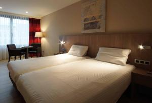 Postel nebo postele na pokoji v ubytování De Keyser Hotel