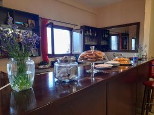 a kitchen with a counter with a vase of flowers at Dimitra in Dháfni