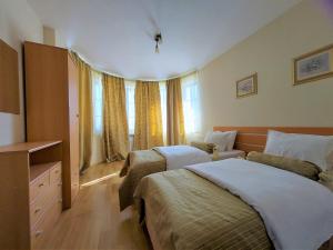 a hotel room with two beds and a window at Pinerose Resort in Bansko +108 photos
