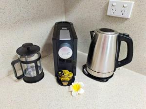a blender and a coffee maker on a counter at Cute City Cottage - 2 Bedroom - The Strand in Townsville