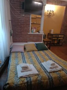 a bedroom with a large bed with towels on it at La Chiocciolina in Lucca
