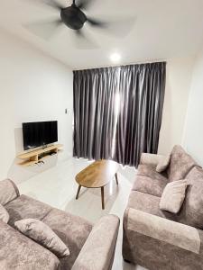 a living room with a couch and a ceiling fan at Cameron 1Room Apartment @ Emerald Avenue Brinchang in Brinchang
