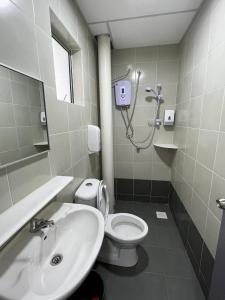 a bathroom with a toilet and a sink at Cameron 1Room Apartment @ Emerald Avenue Brinchang in Brinchang