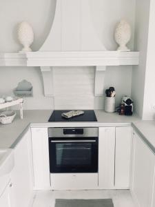 a kitchen with white cabinets and a black oven at SCHLEI LIEBE in Arnis