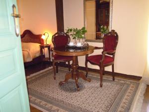 a dining room with a table and two chairs at Atheaton Traditional Guest Ηouse Nafplion in Nafplio
