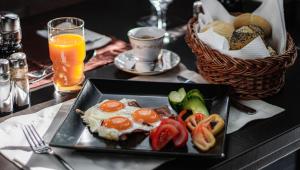 a plate of food with eggs and vegetables on a table at Fakapu Pince és Panzió in Tokaj