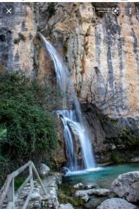 a waterfall on the side of a mountain with a river at Apartamento rural castril in Castril +16 photos