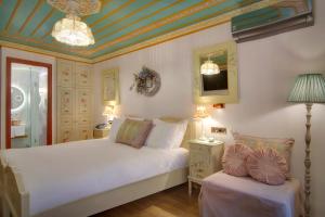 a bedroom with two beds and a blue ceiling at ARCHONTARIKI Historic Boutique Hotel in Ioannina