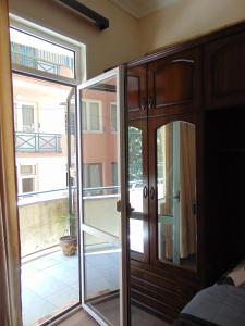 a sliding glass door in a bedroom with a balcony at Apartment in the center of the city - Vera in Tbilisi City