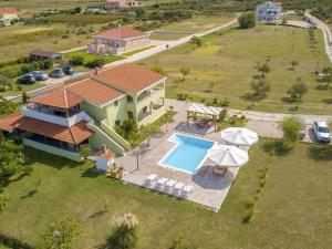 an aerial view of a house with a swimming pool at Lovely apartment with swimming pool in Ljubač