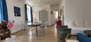 a living room with a table and chairs and a bedroom at Casa ANNA in Calvi