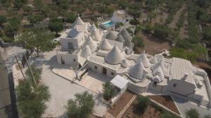 an overhead view of a large white building with turrets at Trulli Loco in Locorotondo