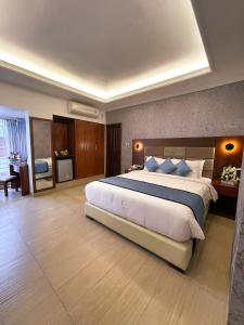 a large hotel room with a large bed in it at Nascent Gardenia Residence in Dhaka