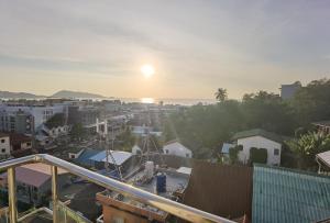 a view of a city with the sunset in the background at Villa Versace Residence in Patong Beach