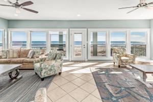 a living room with a view of the ocean at Grotto on the Gulf in Fort Morgan