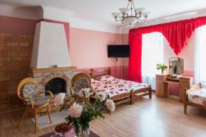 a living room with a bed and a fireplace at Villa Magonīte in Ventspils