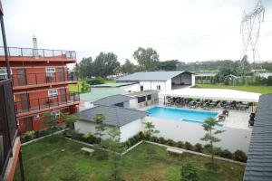 an aerial view of a building with a swimming pool at Vistar Resort & Hotels in Bangalore