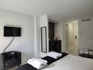 a hotel room with a bed and a television at Urban Spaces Ibiza in Ibiza Town