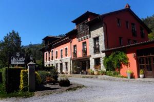 a building with a sign in the middle of a street at Hotel Rural Casa Cueto in Infiesto