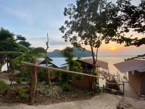 a house with a view of the ocean at sunset at Phi Phi Seaside Bungalow in Phi Phi Don