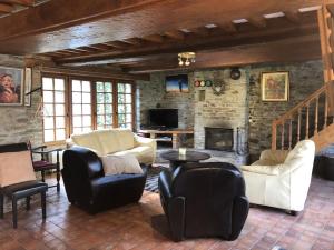 a living room with furniture and a stone wall at la noisette in Saint-Rémy