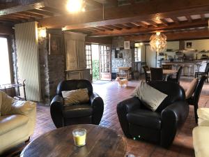 a living room with two chairs and a table at la noisette in Saint-Rémy