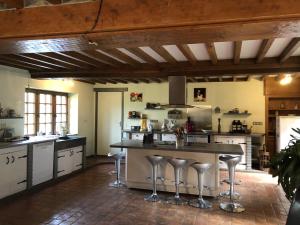 a large kitchen with a large island with bar stools at la noisette in Saint-Rémy