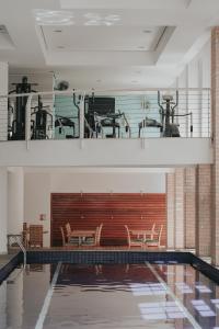 a swimming pool with chairs in a building at Duplex NYC Berrini - 1506 in São Paulo
