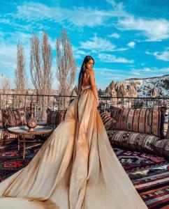 a woman in a wedding dress standing in a room at Grand Cappadocia Hotel in Göreme