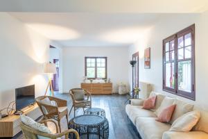 sala de estar con sofá y sillas en VILLA BAÏTA - Maison avec jardin proche de la Dune du Pyla, en La Teste-de-Buch