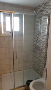 a bathroom with a shower and a toilet at La Veranda Hotel in Larnaca