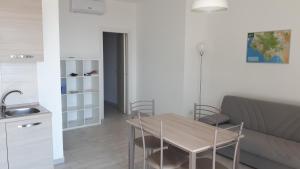 a living room with a table and a couch at Le Pigne casa vacanze. in Pollica +22 photos