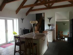 a kitchen with a table with a vase of flowers on it at Station House Lanark Bed and Breakfast in Lanark