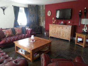 a living room with a couch and a coffee table at Station House Lanark Bed and Breakfast in Lanark