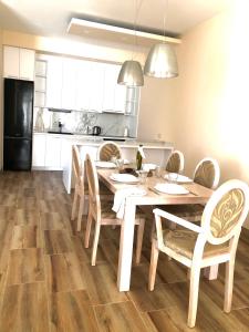 a kitchen with a dining room table and chairs at Lovely Apartment Sveti Stefan in Sveti Stefan