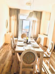 a dining room with a wooden table and chairs at Lovely Apartment Sveti Stefan in Sveti Stefan