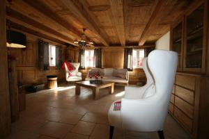 a living room with a couch and a table at Les Authentics - Le Domaine d'Autrefois & Spa in Bolsenheim