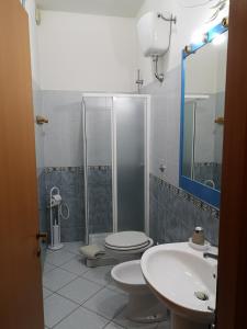 a bathroom with a shower and a toilet and a sink at Casa vacanze Rose E Fiori Sardegna in San Vito