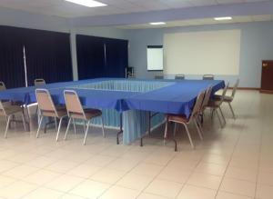 a conference room with a blue table and chairs at Sunset Shores Beach Hotel in Kingstown +37 photos