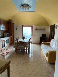 a living room with a table and a couch at Casa Belvedere in Ravello +13 photos
