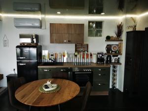 a kitchen with a wooden table and a black refrigerator at Ferienhaus Sonja in Donnerskirchen