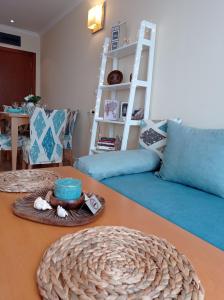 a living room with a table with a hat on it at Lilia Sun Apartment in Sozopol