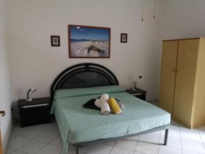 Ένα ή περισσότερα κρεβάτια σε δωμάτιο στο Apartment Rose e Fiori Sardegna