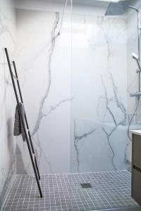 a bathroom with a shower with a glass door at Magnifique Appartement Design Parking Chiberta in Anglet