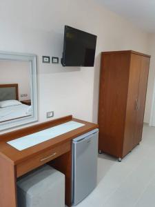 a bathroom with a sink and a mirror at Victoria Studio Himara in Himare