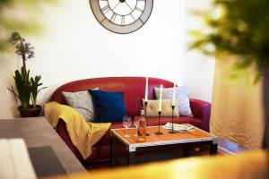 a living room with a red couch and a table at Les Lofts De Provins Apt 2 in Provins