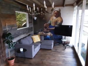 a man standing in a living room with a couch at Lombok in Westerbork