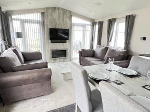 a living room with a couch and a table at Lakes End, Dog Friendly in South Cerney