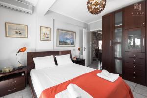 a bedroom with a large bed and a chandelier at Roadhouse, Nilie Hospitality MGMT in Flogita