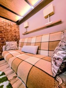 a couch in a room with a brick wall at Old Town #Menorah #MostCity in Dnipro